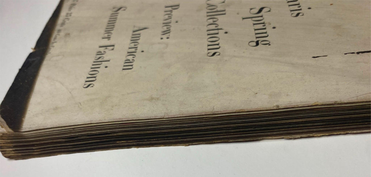 Close-up view of the side of the vintage Vogue Magazine April 1, 1947, displaying its worn edges and vintage marks, a testament to its history as a prominent fashion magazine.
