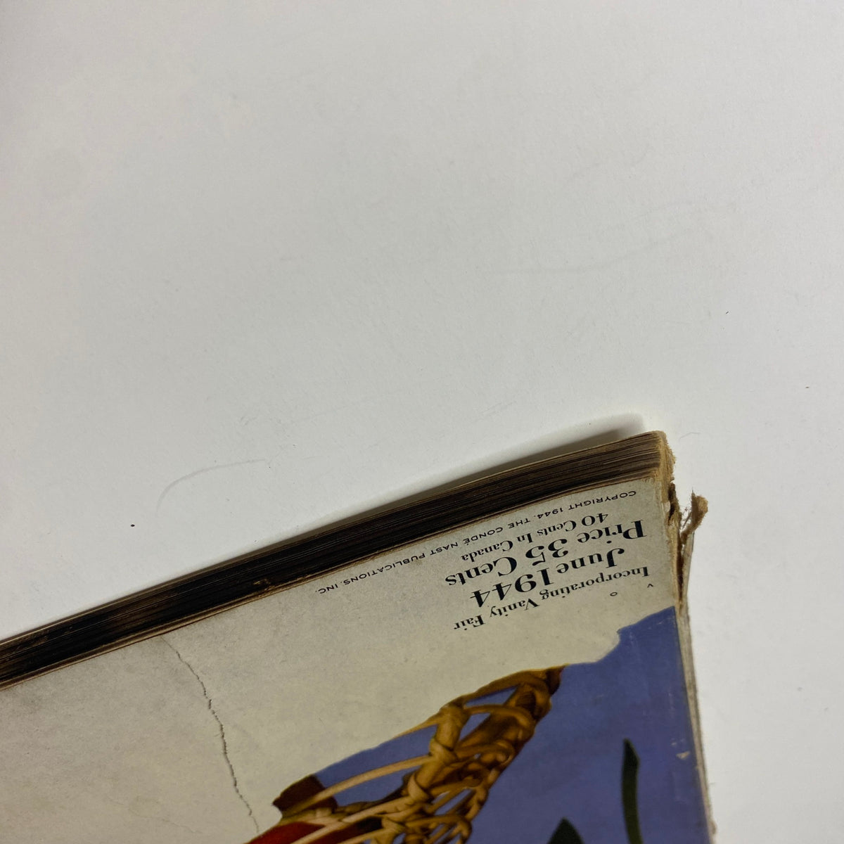 Vogue Magazine June 1944 - All-Summer-Long Fashions by Haanel Cassidy displaying a close-up of magazine spine with notable wear, indicative of its vintage condition.