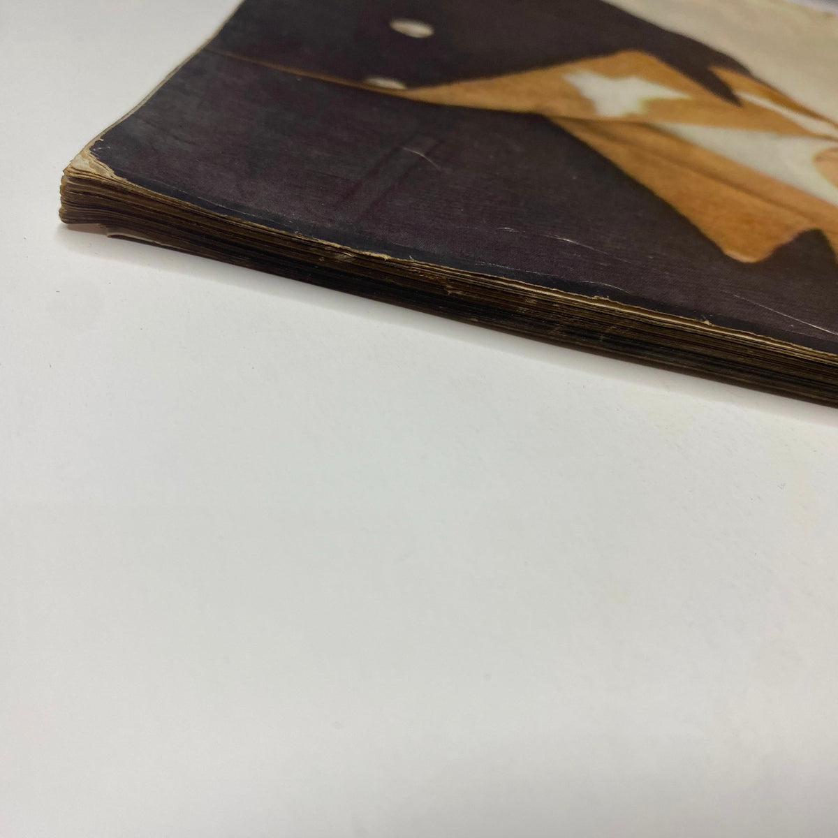 Another angle of the vintage magazine spine showing wear in Vogue Magazine August 15, 1952 issue, indicative of its age and history.