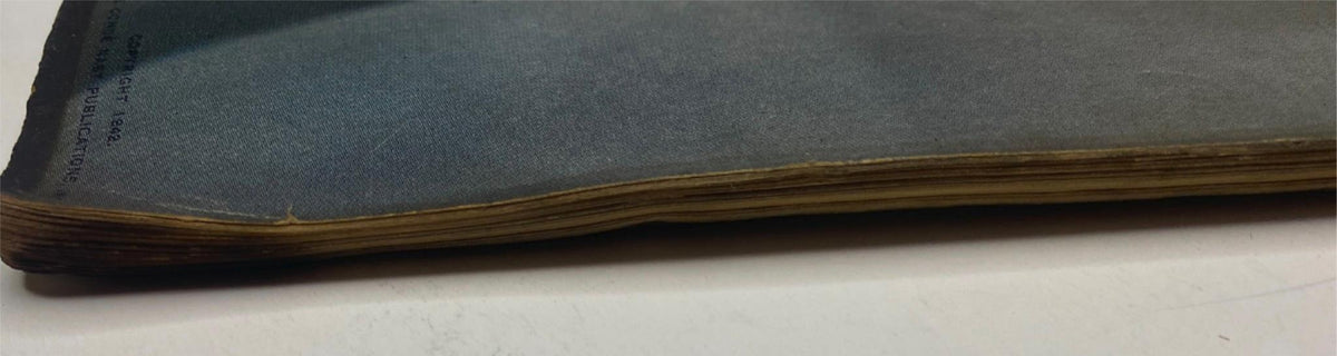 Side view of the April 15, 1942 Vogue Magazine, highlighting the aged spine and binding wear typical of vintage magazines, part of the 'Our Ration-al Lives' edition.