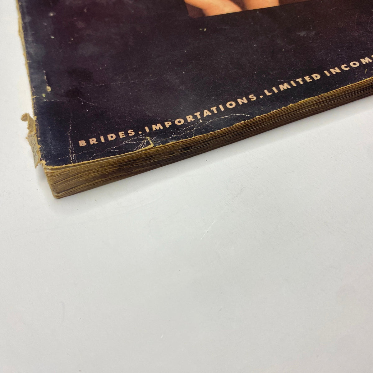 Close-up of the worn spine of Vogue Magazine April 1, 1939, illustrating the vintage condition of the publication.