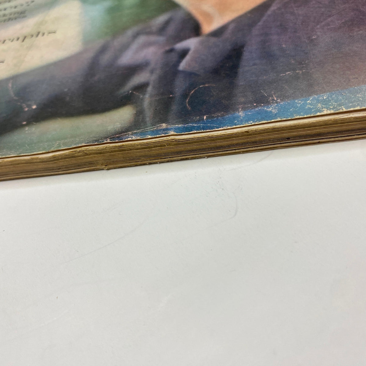 The bottom edge of a page from Vogue Magazine March 1, 1960, emphasizing the aged appearance of the magazine with frayed edges, reflecting its original vintage condition.