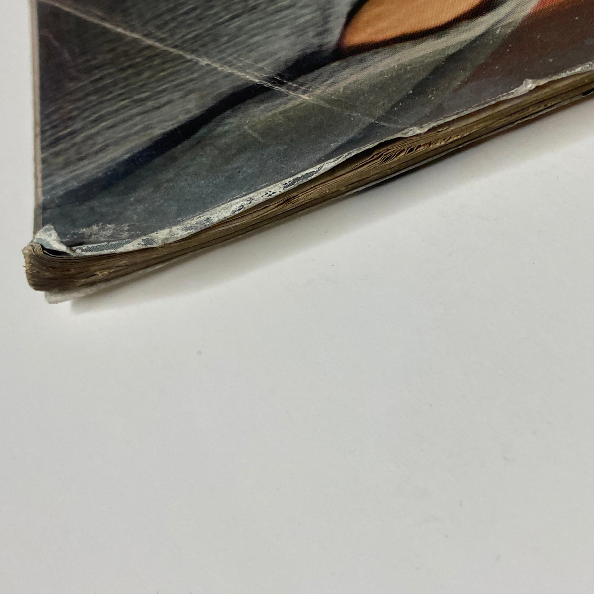 Detailed image of the edge wear on Vogue Magazine January 1, 1962, illustrating the vintage characteristics of this collectible magazine.