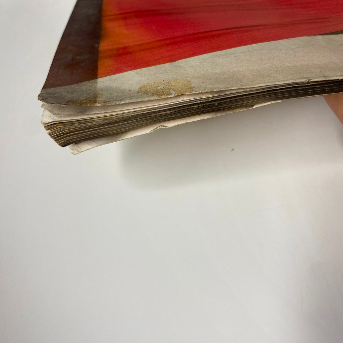 Close-up view of the spine edge of Vogue Magazine October 1, 1954 Jean Patchett Cover by Horst P. Horst, showcasing vintage wear and condition.