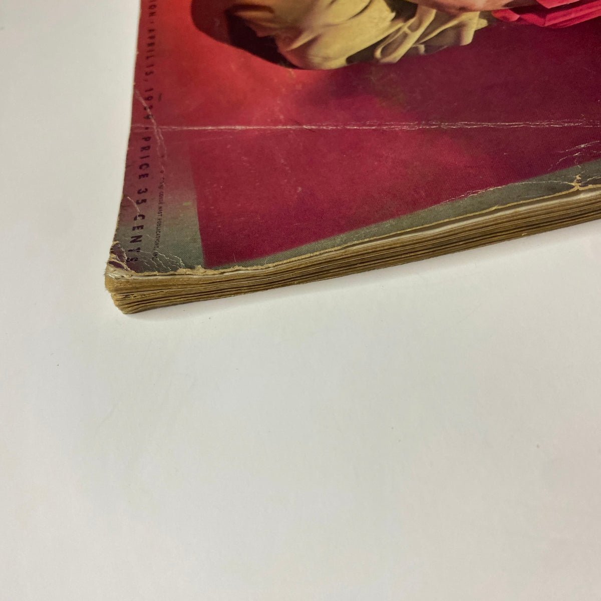 Close-up of the cover of Vogue Magazine April 15, 1939, showing slight fraying and discoloration, emphasizing its vintage condition.