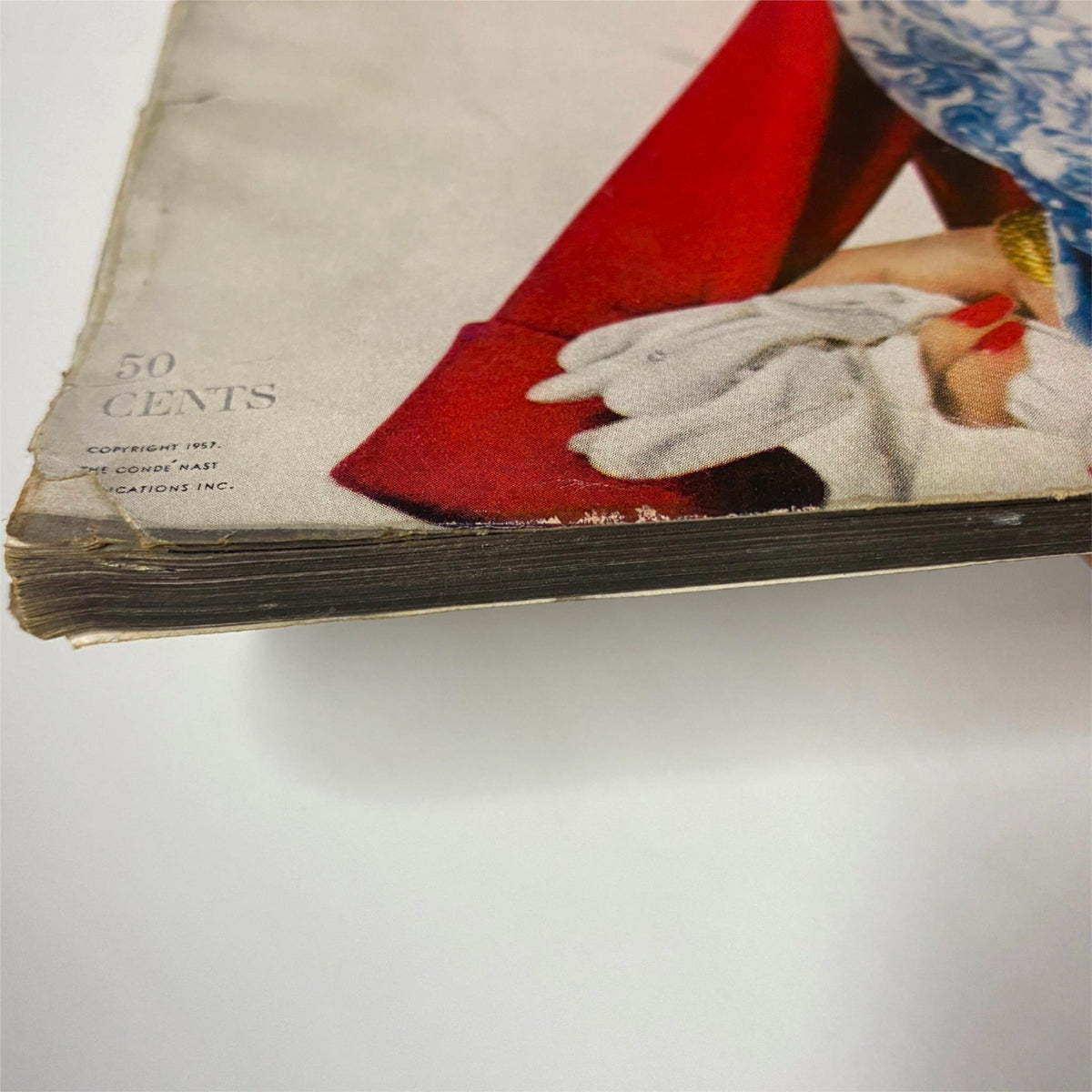 Vogue Magazine February 1, 1957 detail showing the worn condition of the magazine, emphasizing its vintage value.
