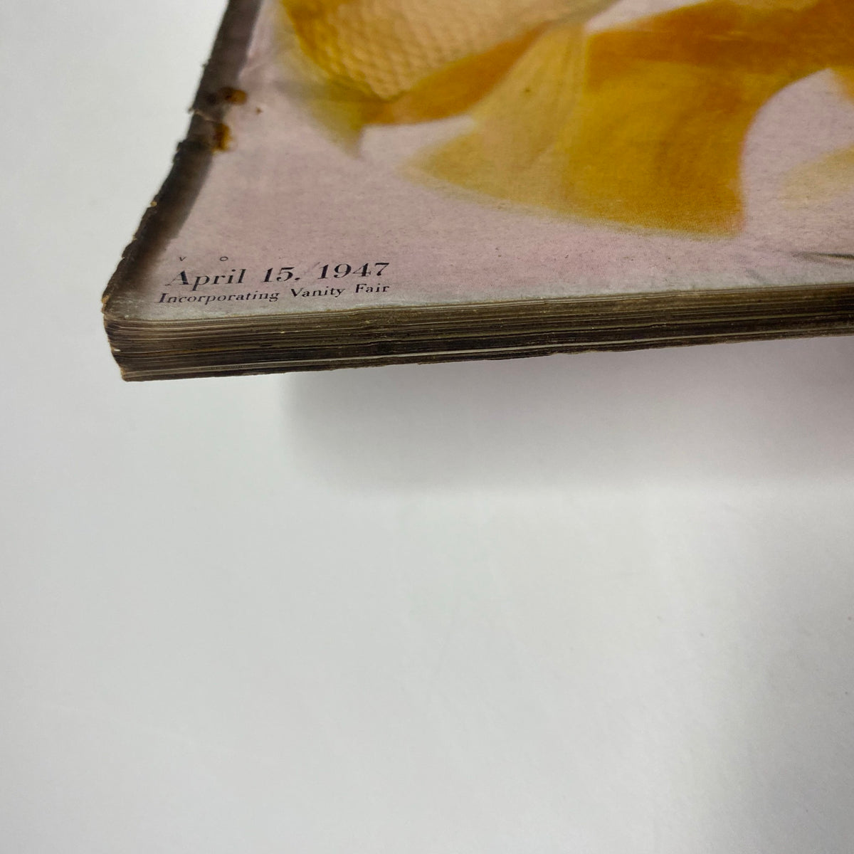A close-up view of the spine of the Vogue Magazine April 15, 1947 Decorating Issue Cover by Irving Penn, showing the publication date and slight wear from aging.