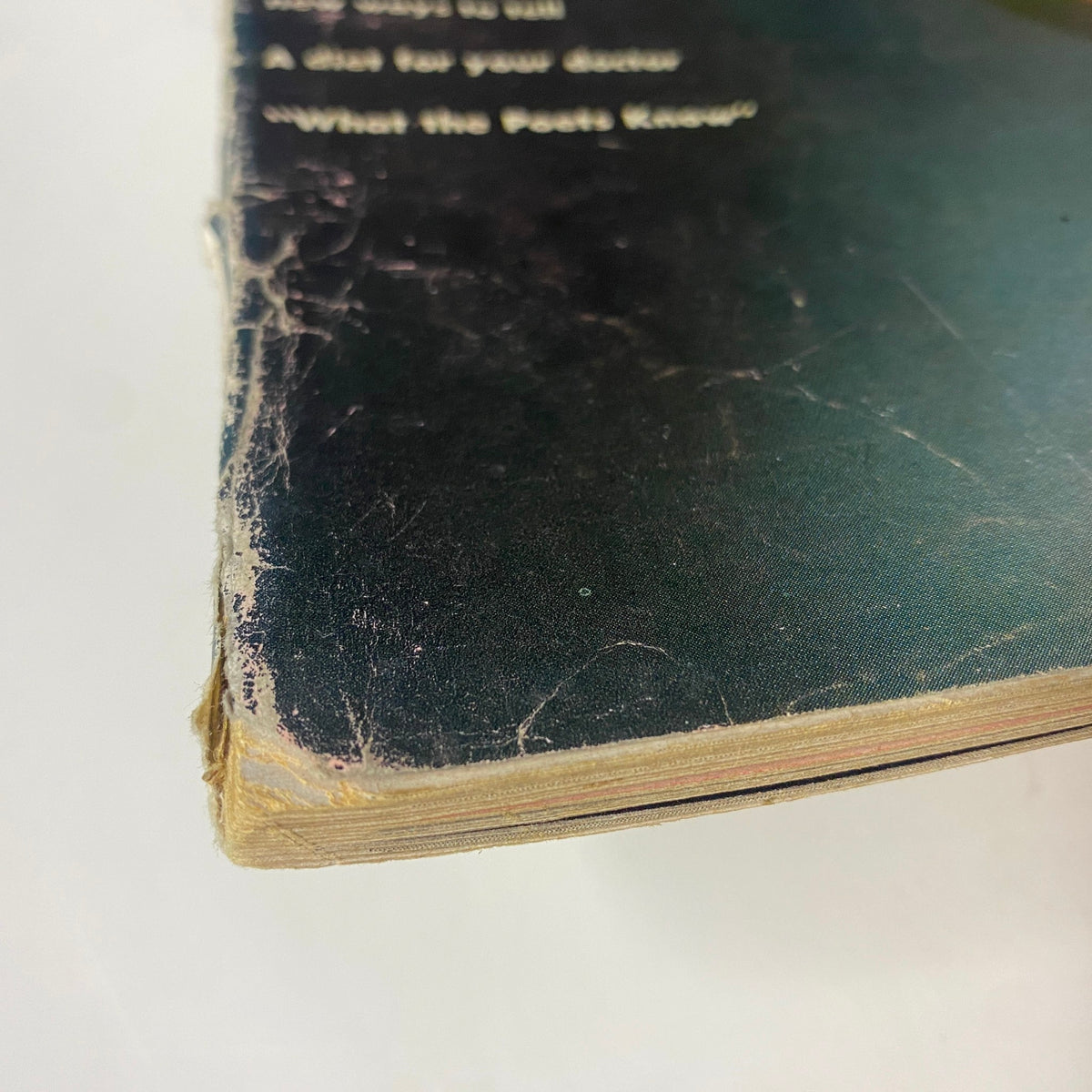 Detail image of the spine of Vogue Magazine November 1, 1961, showing signs of wear and age, indicative of its vintage condition.
