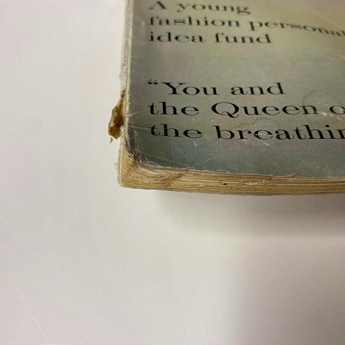 Spine view of Vogue Magazine March 15, 1960, showcasing wear and tear with a visible split, highlighting its vintage characteristics.
