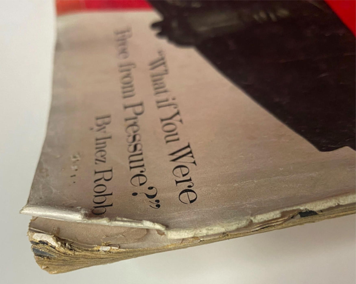 Detailed view of the October 1, 1960 Vogue Magazine showing the frayed edge of the spine, emphasizing its authentic vintage condition and historic significance.