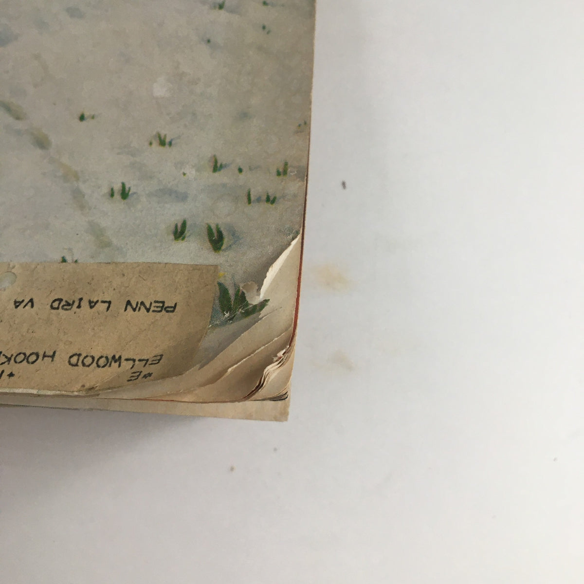 Side view of The Saturday Evening Post from May 5, 1962, displaying wear and tear including a small rip and an address label, highlighting its vintage condition.