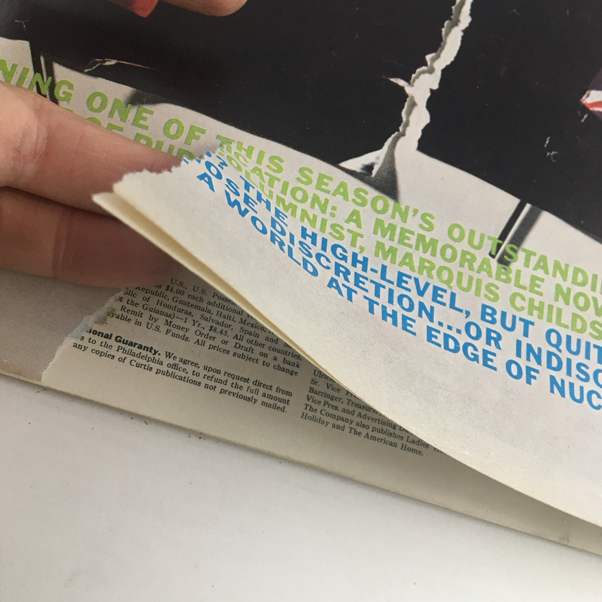 Detail shot of the inside cover page of The Saturday Evening Post October 14, 1961, revealing wear and tear on the edge, emphasizing its vintage character.
