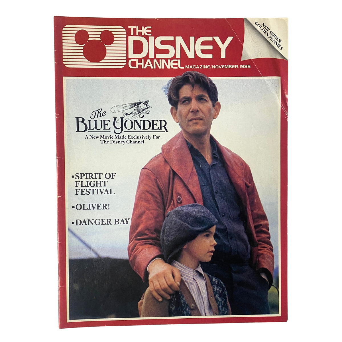 The Disney Channel Magazine November 1985 cover featuring 'The Blue Yonder' and 'Danger Bay', showcasing a man in a red jacket with a young boy, highlighting Disney's adventure programming.