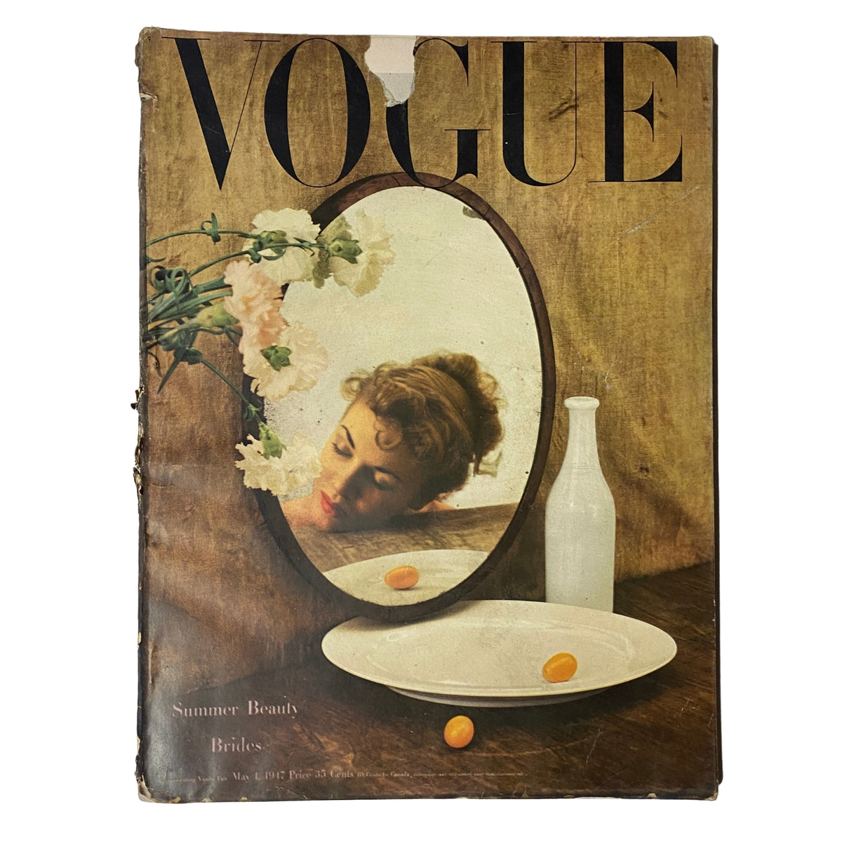 Cover of Vogue Magazine May 1, 1947 featuring Summer Beauty Brides by Irving Penn with a reflection in a mirror and floral accents.