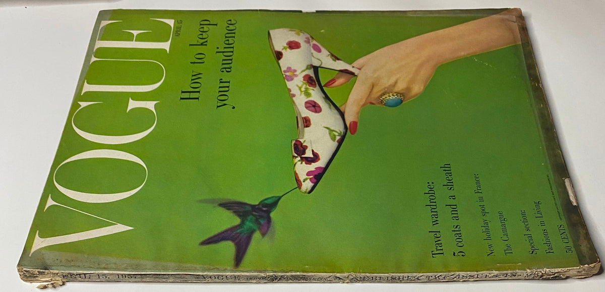 Close-up view of the cover of Vogue Magazine April 15, 1957, with the title 'How To Keep Your Audience'. The image highlights a stylish shoe on a green background, reflecting the elegance of 1950s fashion.