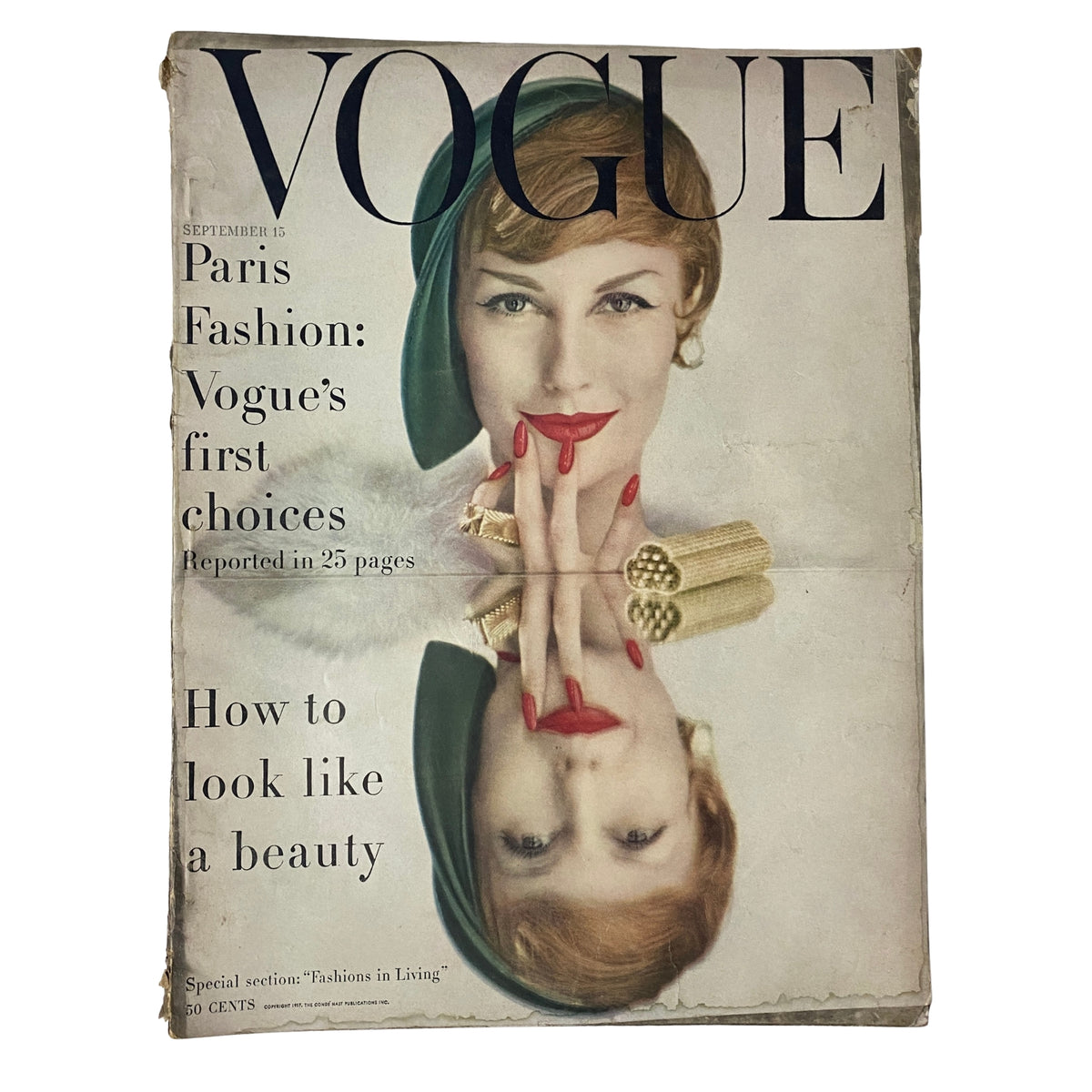 Cover of Vogue Magazine from September 15, 1957 featuring Mary Jane Russell, photographed by John Rawlings. The design showcases a stylish woman with striking red nails, reflecting elegance and fashion sophistication of the era.