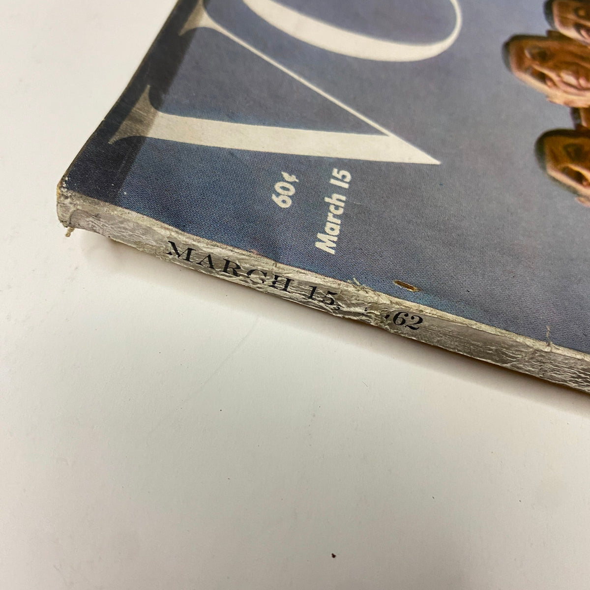 Close-up view of the March 15, 1962 issue date on the spine of Vogue Magazine, indicating its historical significance in the fashion industry.
