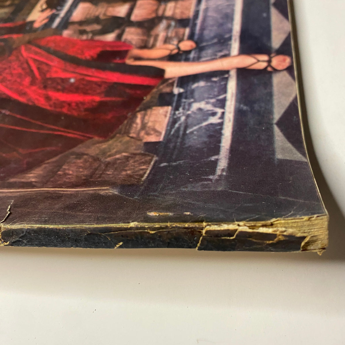 Close-up of the edge of Vogue Magazine November 1, 1955 Anne St. Marie cover showing wear and vintage characteristics.