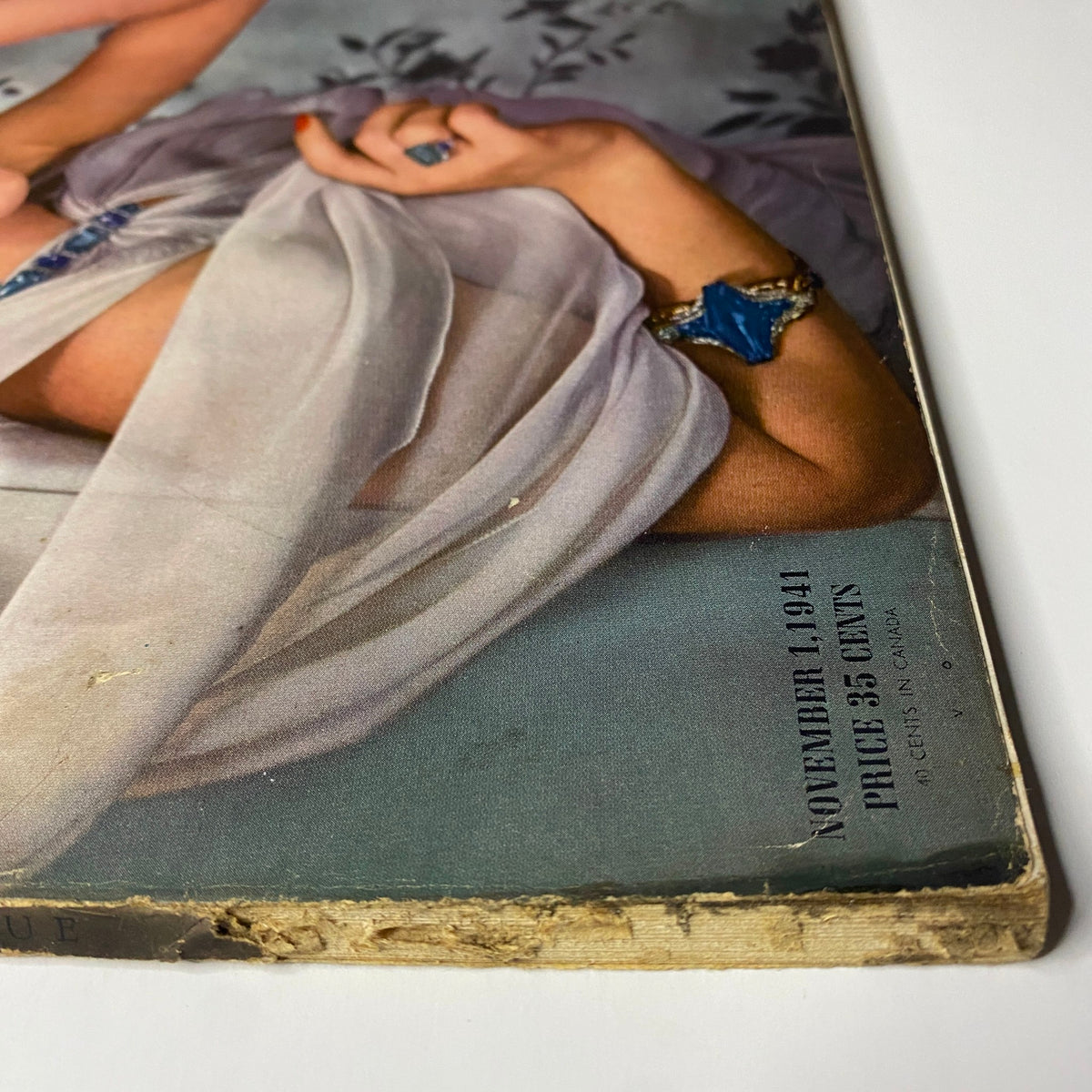 Cover detail of Vogue Magazine November 1, 1941 featuring Bettina Bolegard, photographed by Horst P. Horst, highlighting vintage elements and wear indicative of its historical significance.