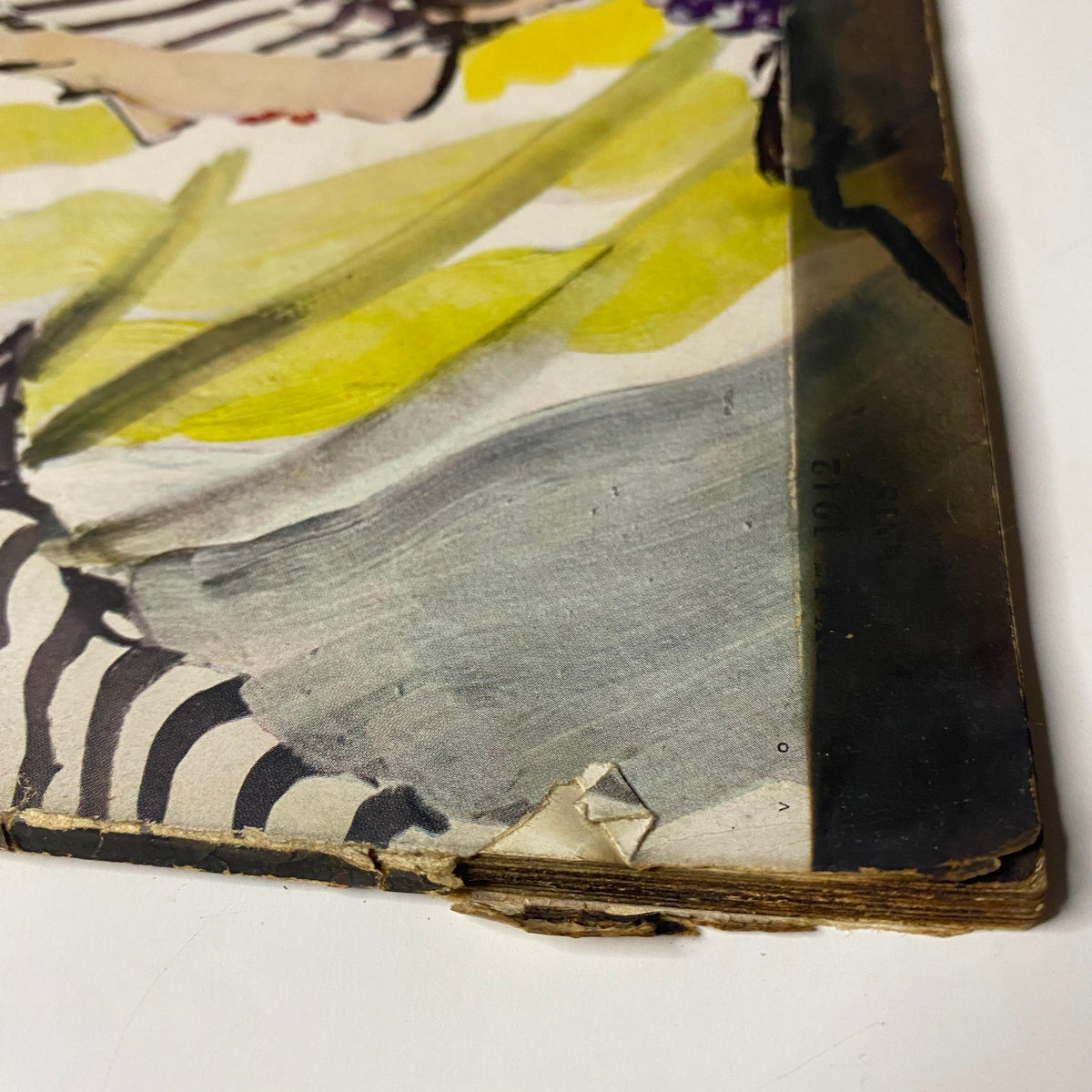 Detailed view of the worn corner of Vogue Magazine January 15, 1942, highlighting the vintage design theme 'New Design for Our Double-Duty Lives'.
