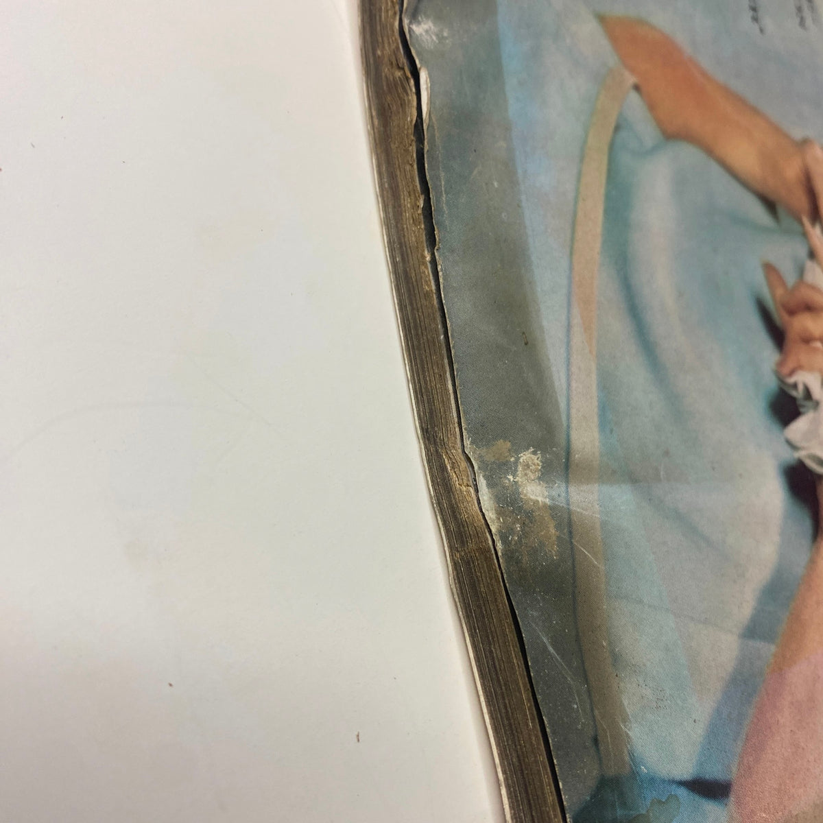 Close-up image showing the spine of Vogue Magazine August 1, 1961, featuring Monique Chevallier by John Rawlings, highlighting wear and age characteristics.