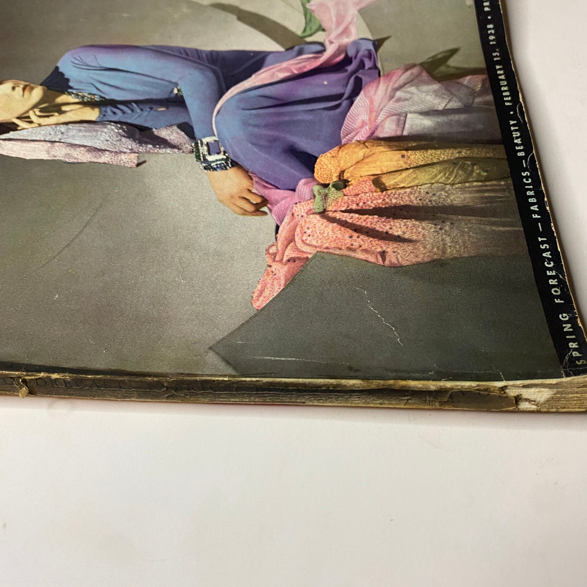 Detail of the Vogue Magazine February 15, 1938 cover showing fabric swatches with a colorful palette, highlighting the fashion forecast theme from the issue.