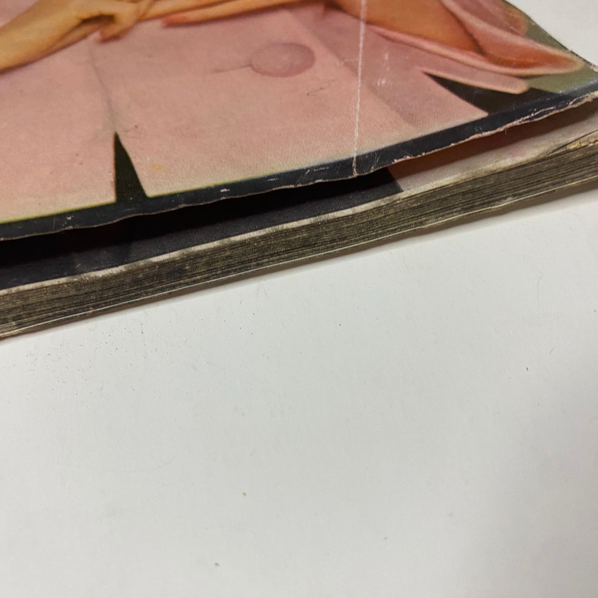 Another angle of the spine of Vogue Magazine June 1961 Dorothy McGowan Cover by Tom Palumbo, highlighting the wear and vintage traits of this iconic publication.