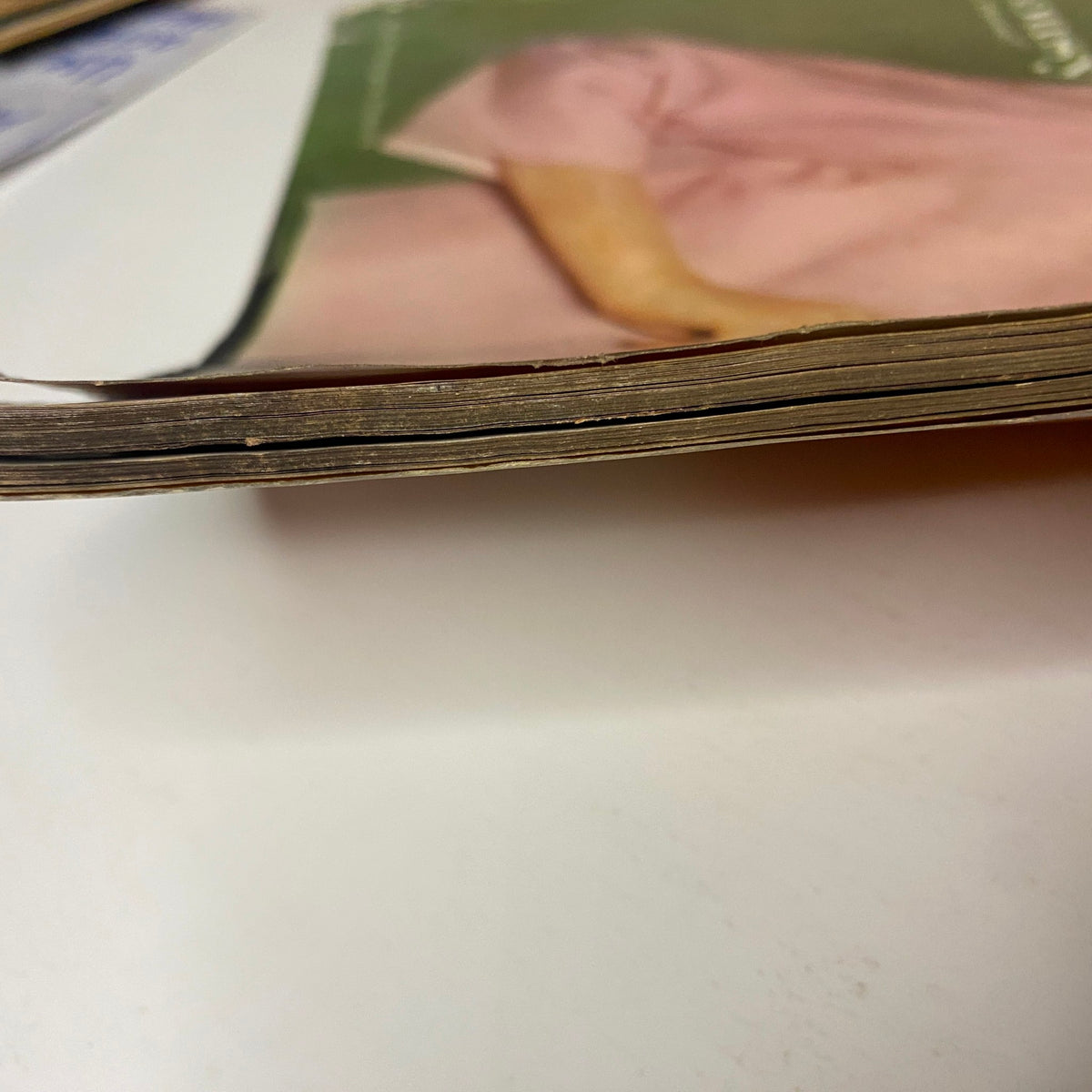 Side view of Vogue Magazine June 1961 Dorothy McGowan Cover by Tom Palumbo, showcasing the aged edges and condition typical of vintage magazines.