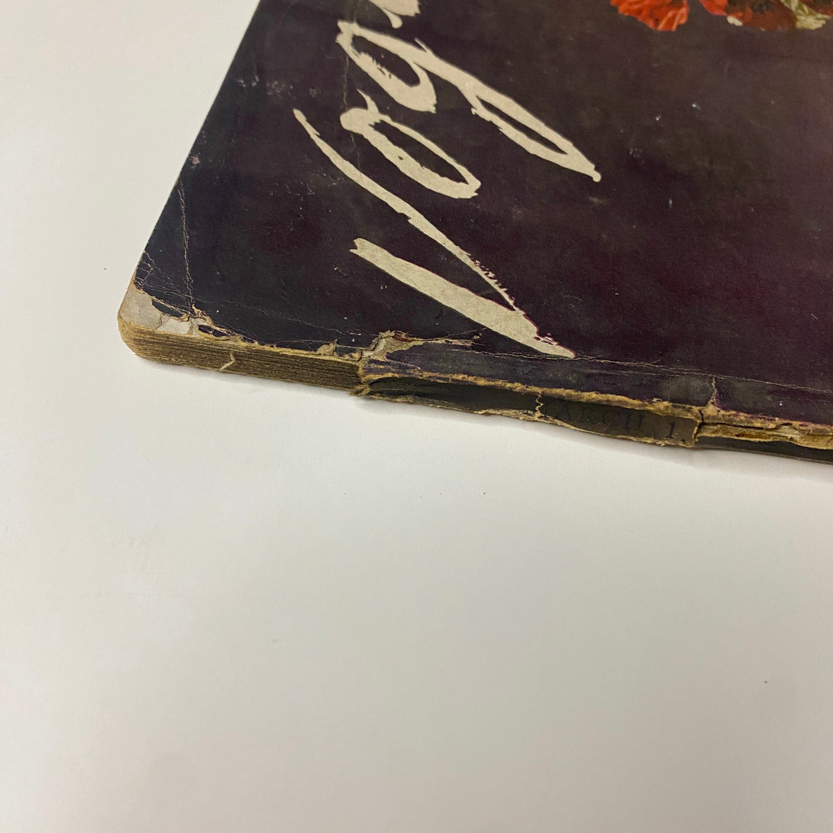 Side view of Vogue Magazine March 1, 1941 highlighting the worn edges and spine, reflecting its historical significance.