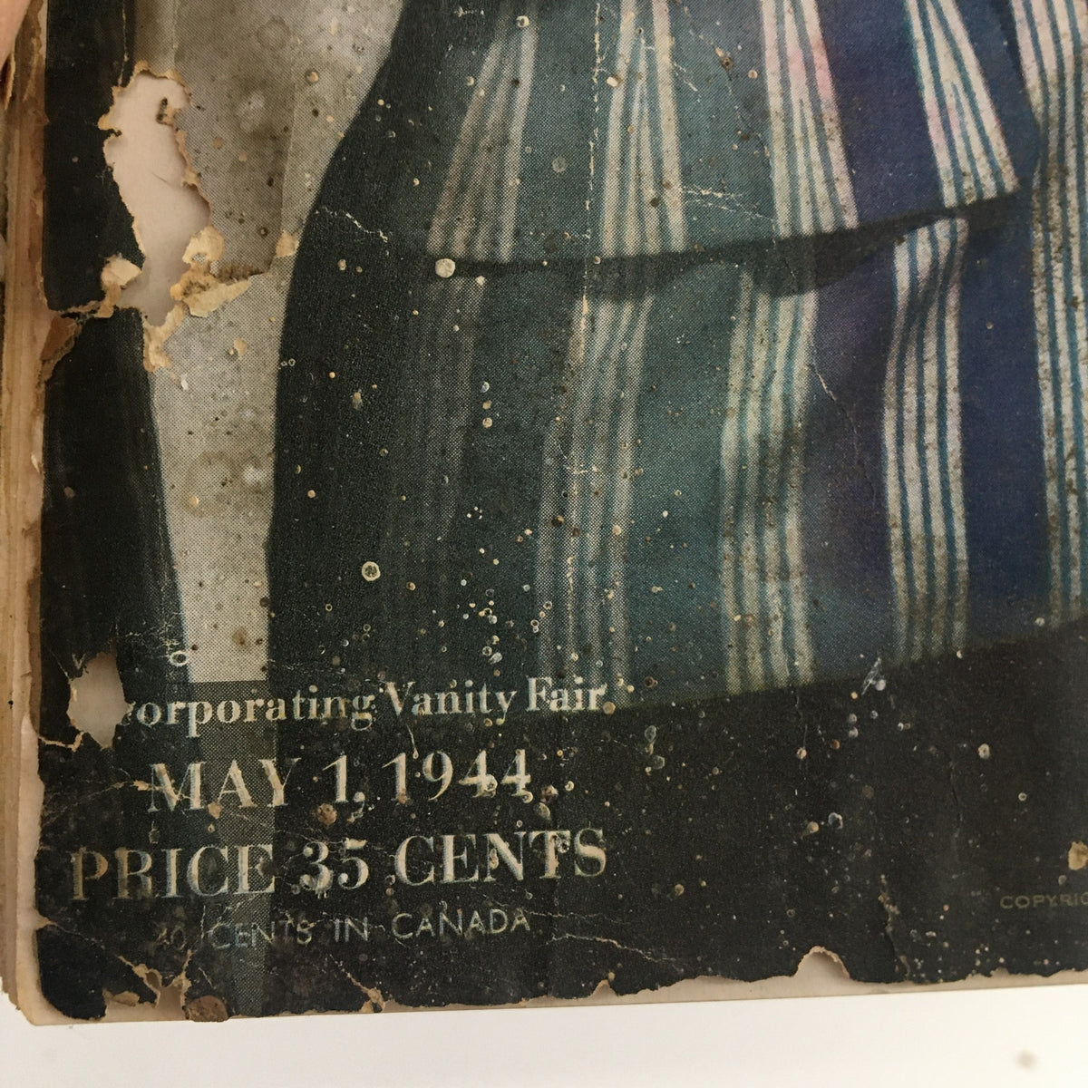 Close-up of the date and pricing on the VTG Vogue Magazine May 1 1944, showcasing the wear and vintage charm of this collectible publication.