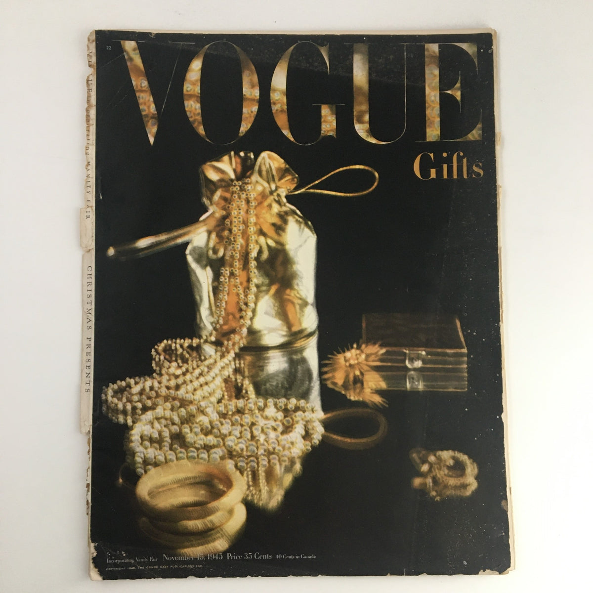 Cover of the VTG Vogue Gifts Magazine November 15, 1945 showcasing a decorative gold gift bag with jewelry, highlighting Christmas gift ideas from post-war America.