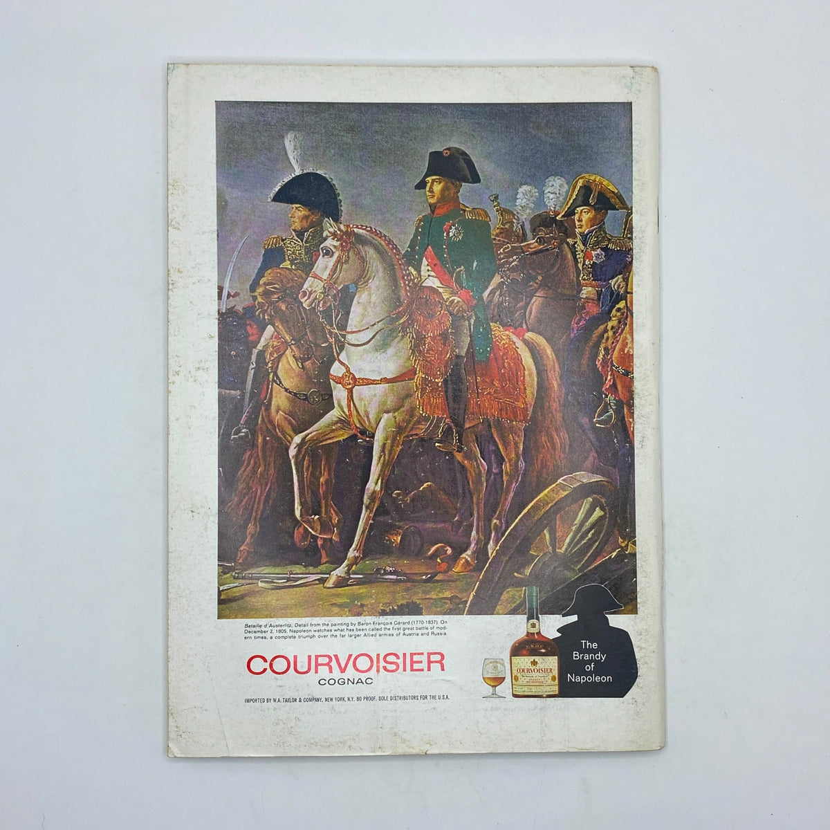 Cover of a Courvoisier Cognac advertisement, showcasing historical figures on horseback, promoting the brand as 'The Brandy of Napoleon'.