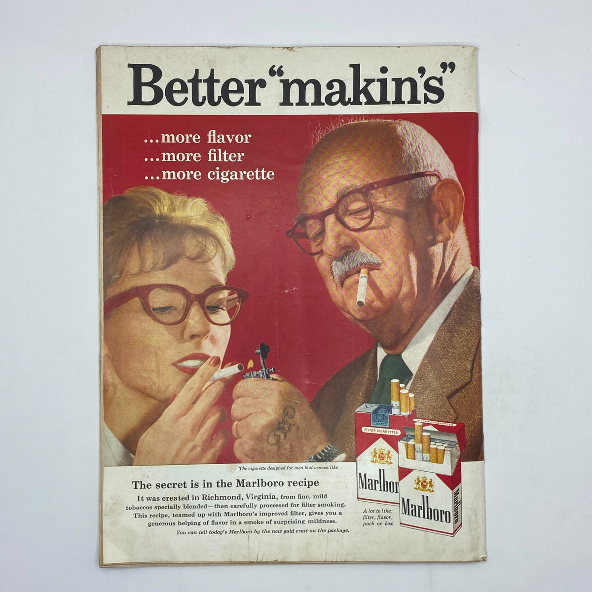 Vintage advertisement for Marlboro cigarettes featuring a woman and a man sharing a lighter, showcasing the slogan 'Better 
