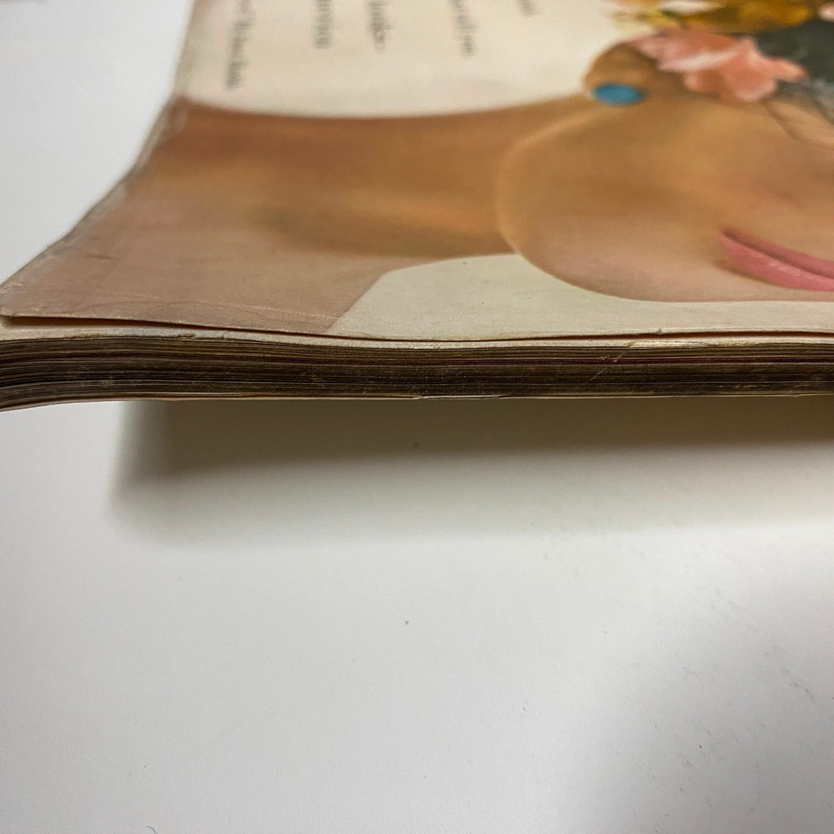 Side view of the pages of Vogue Magazine March 1, 1959 featuring Isabella Albonico, illustrating the aged paper and slight curling associated with vintage magazines.