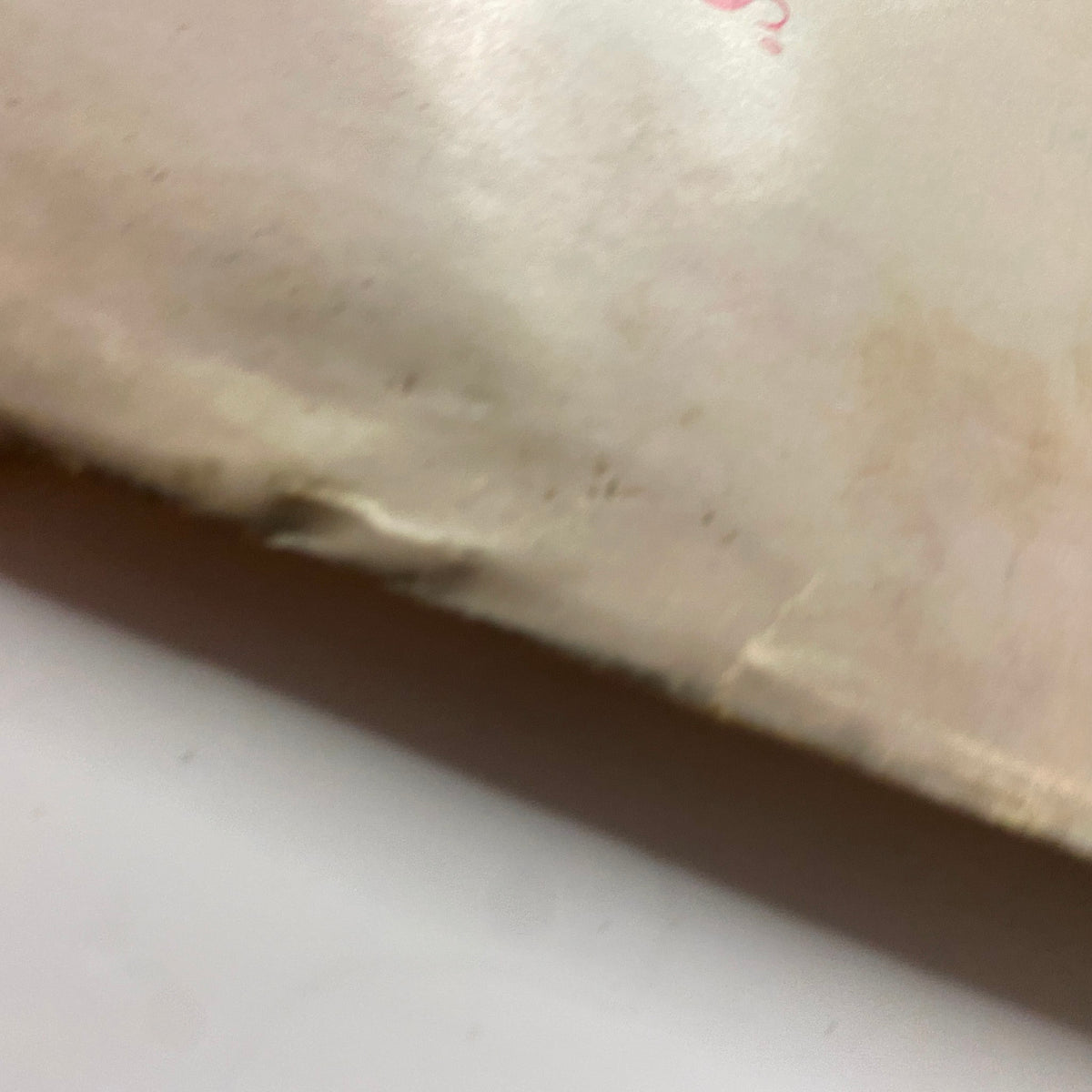 Vogue Magazine March 1, 1959 displaying wear on the back cover, highlighting the vintage characteristics with creases and discoloration.