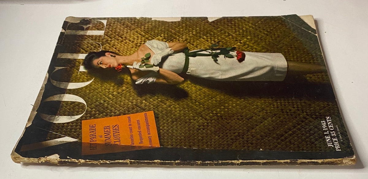 Side view of Vogue Magazine June 1, 1943 displaying the Florence Dornin cover by John Rawlings, highlighting vintage wear and an advertisement for summer clothing.