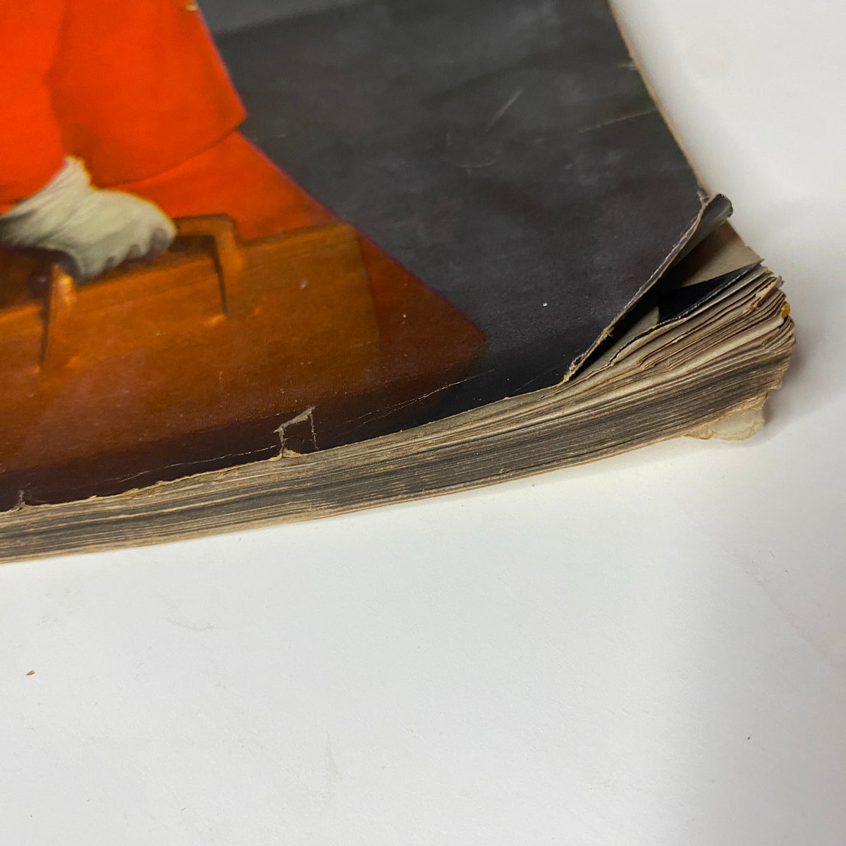 Close-up of the spine of Vogue Magazine February 15, 1945, showing wear and tear with frayed edges and signs of age.