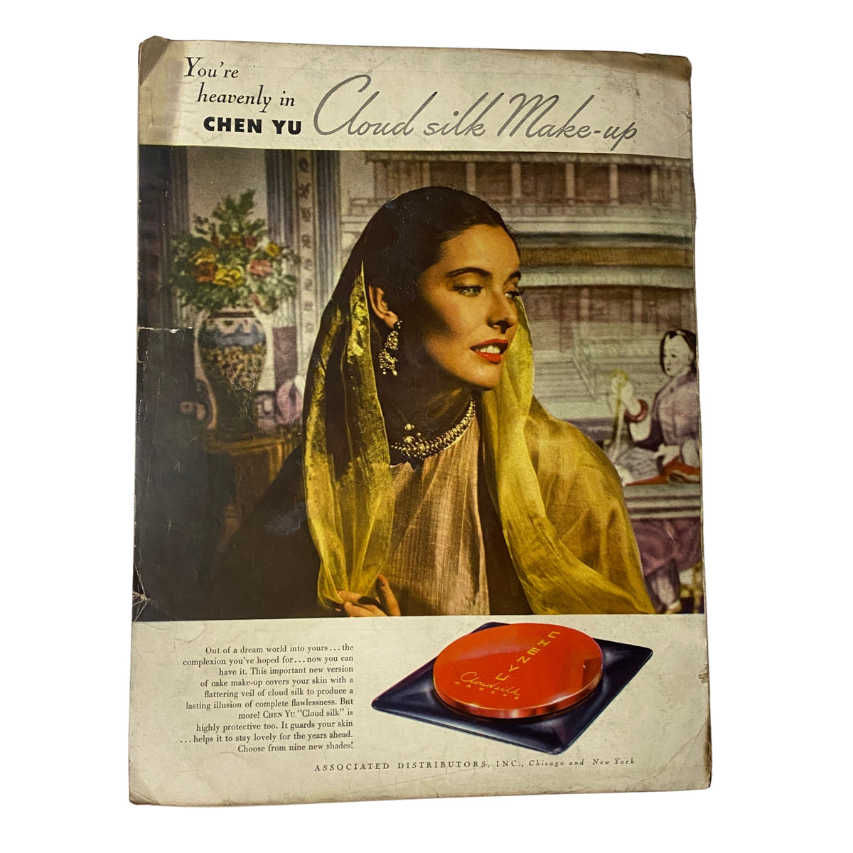 Vintage advertisement featuring a woman wearing a yellow veil promoting Chen Yu Cloud Silk Make-up, from Vogue Magazine February 15, 1945, Betty McLauchlen by Horst P. Horst.