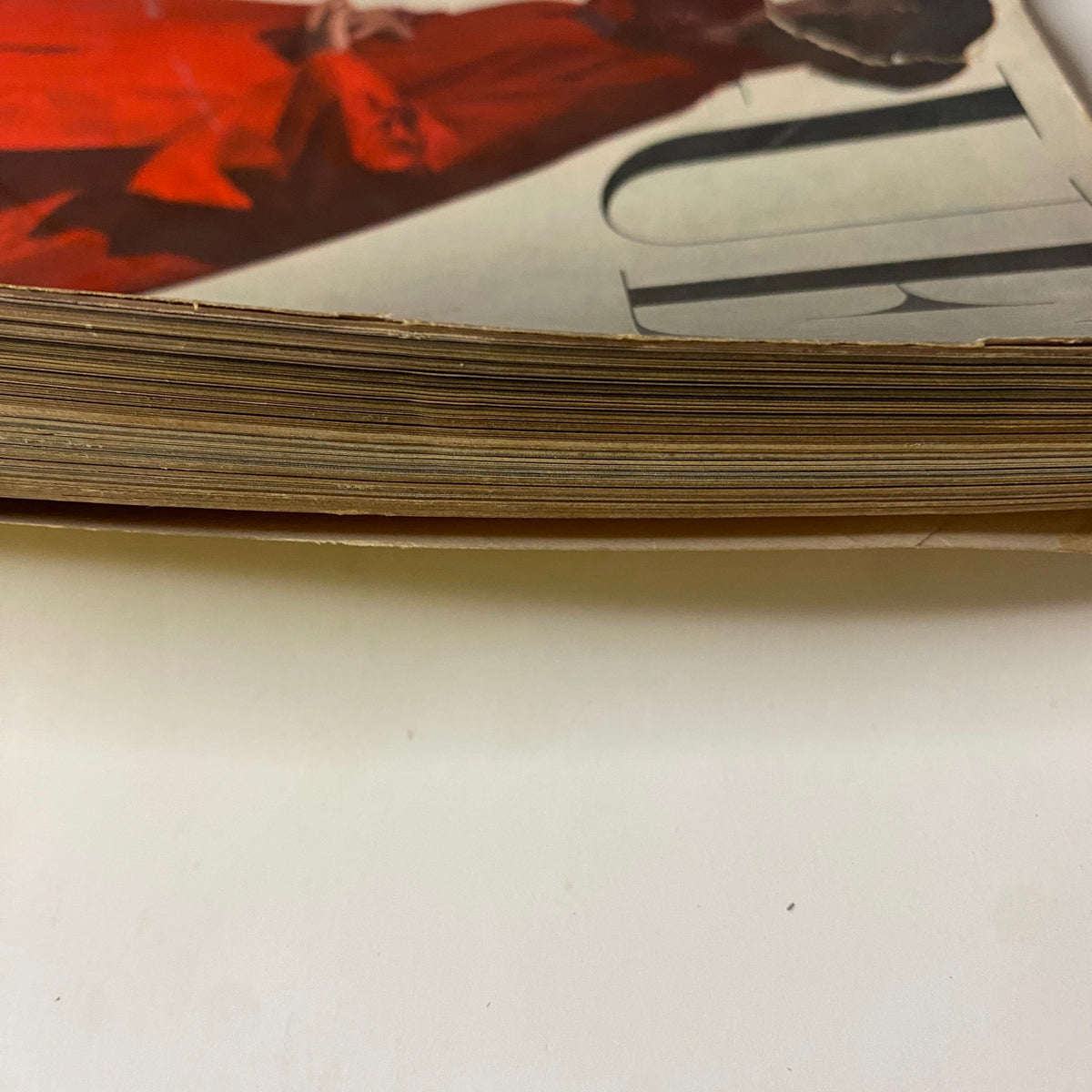 Edge detail of Vogue Magazine November 1, 1946, showcasing aged pages. This view emphasizes the magazine’s historical significance and vintage qualities.