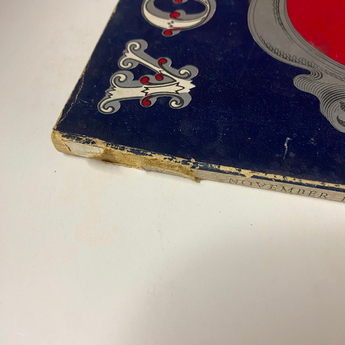 Close-up of the spine damage on Vogue Magazine November 15, 1941 The House of Vanderbilt, highlighting wear and tear on the edge.