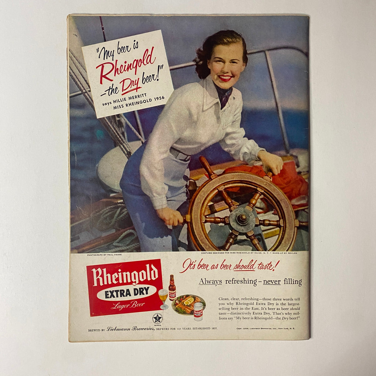 Advertisement page featuring Rheingold Extra Dry beer from 1956, highlighting a vintage image of a woman sailing, from Gourmet Magazine August 1956.