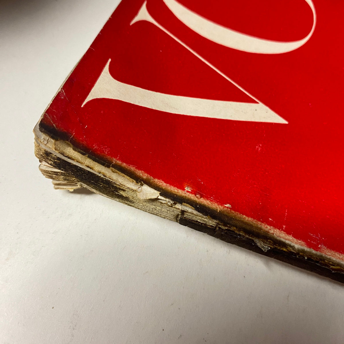 Side view of Vogue Magazine February 1, 1955 Americana Number 1955, displaying the worn edges and vintage characteristics of the magazine's cover.