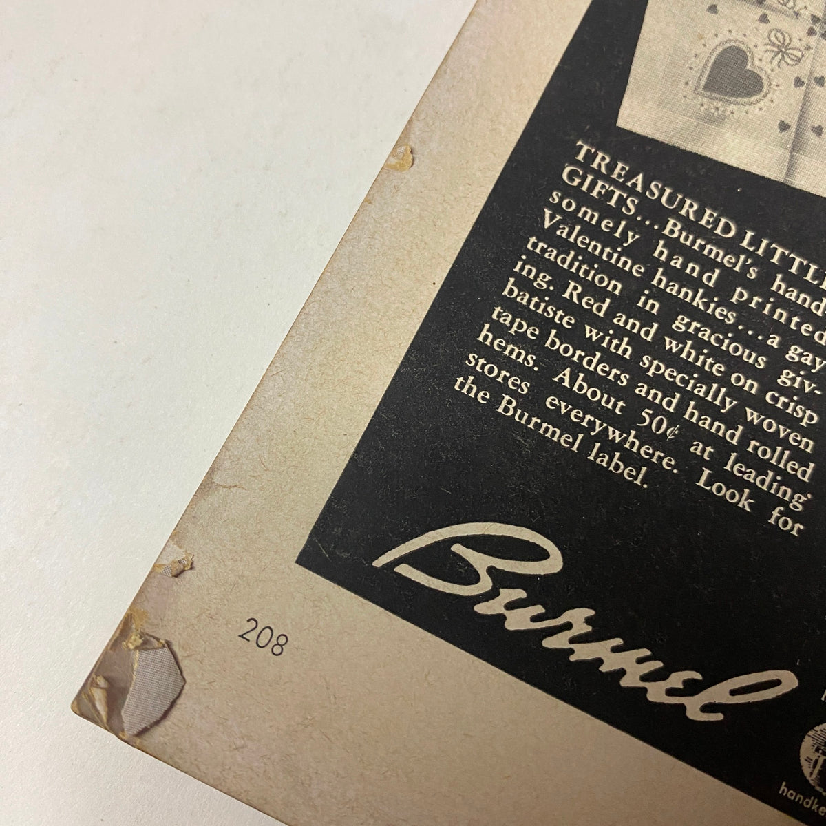 Vogue Magazine February 1, 1955 Americana Number 1955 GD Interior showing the bottom corner with page number 208, featuring vintage advertisements, scuffed edges, and overall signs of age reflecting its collectible nature.