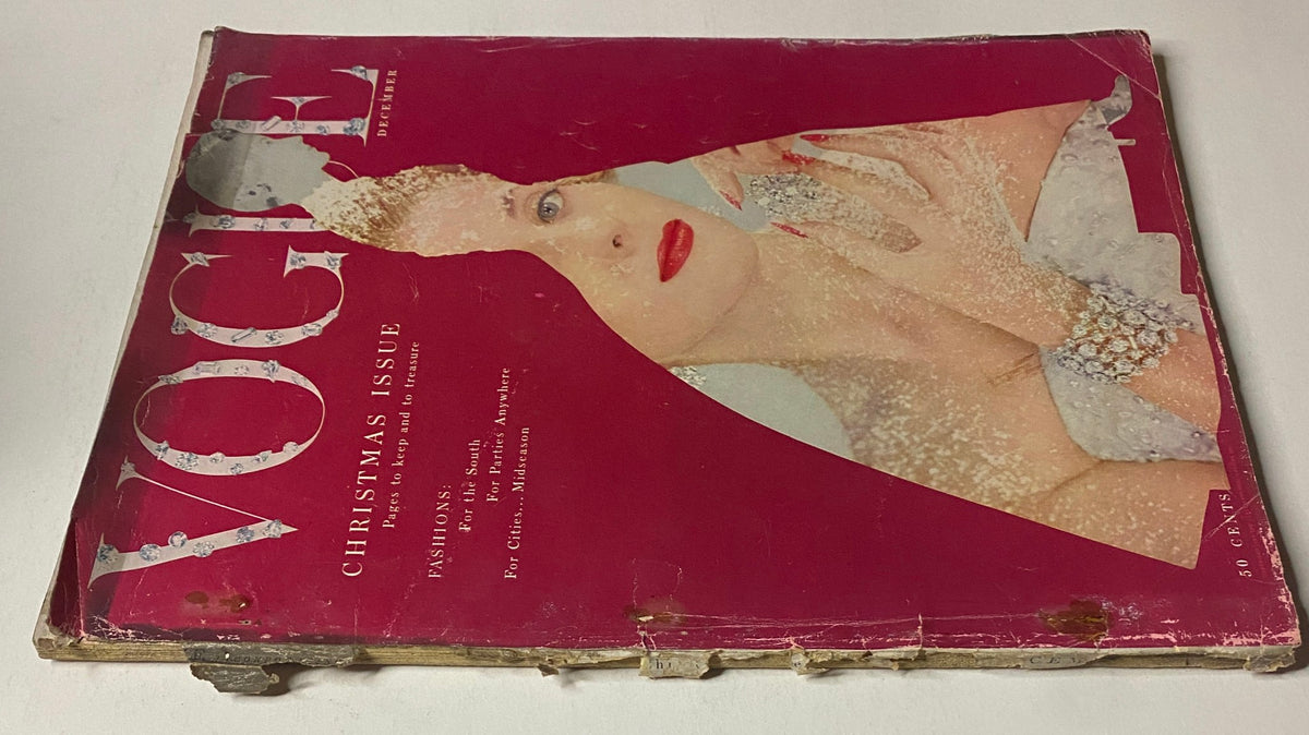 Front view of Vogue Magazine December 1953 featuring Kathleen Wallace by Erwin Blumenfeld. The cover highlights a holiday aesthetic with a glamorous portrait of a woman, showcasing some damage and vintage characteristics.