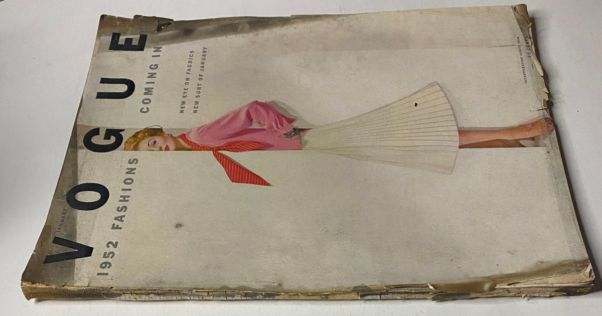 Close-up of the January 1952 Vogue Magazine cover, highlighting a model's outfit and the magazine's worn edges, indicative of its vintage condition.