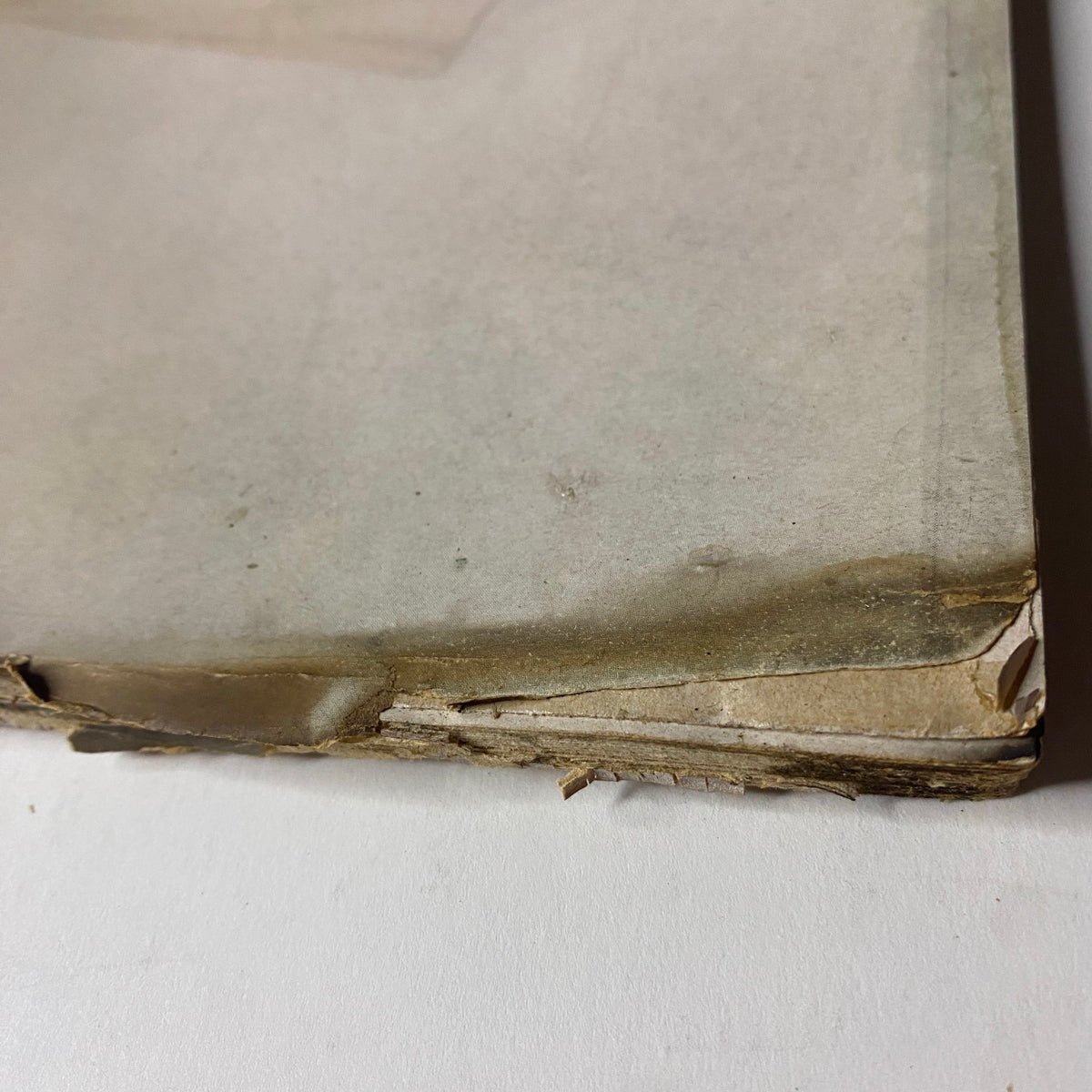 Bottom corner of the January 1952 Vogue Magazine revealing paper deterioration, showcasing the magazine's authentic vintage characteristics.