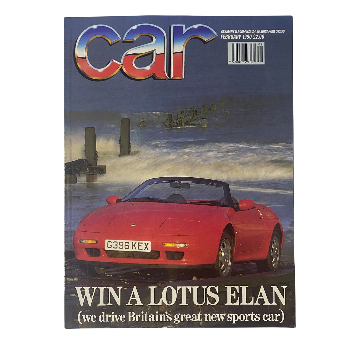 Cover of Car Magazine UK Import February 1990 featuring the headline 'WIN A LOTUS ELAN' with a striking red Lotus Elan convertible against a scenic coastal background.