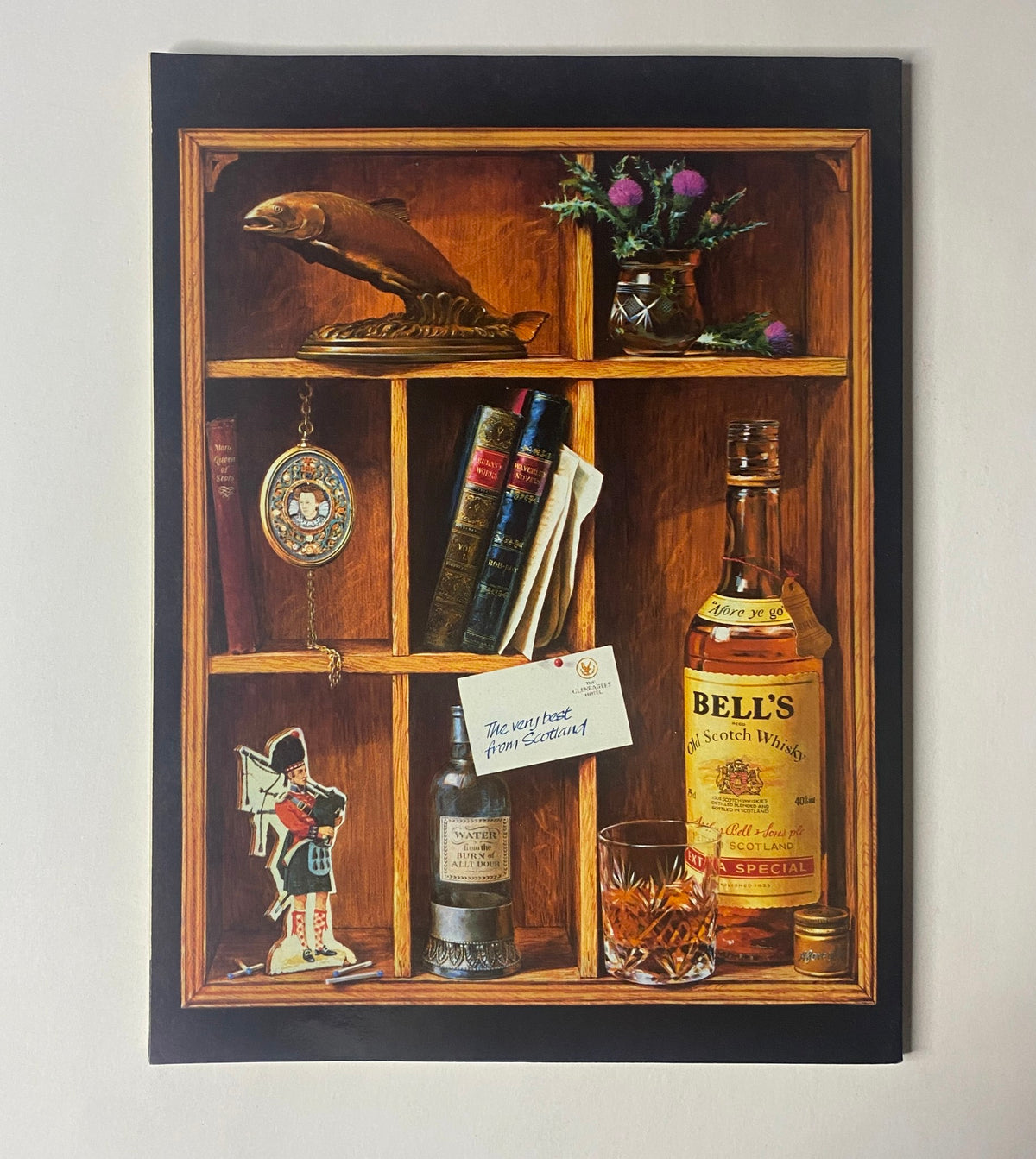 An artistic wooden shelf display with books, a bottle of Bell's Scotch Whisky, and various decorative items, unrelated to the CAR Magazine, September 1989 theme.