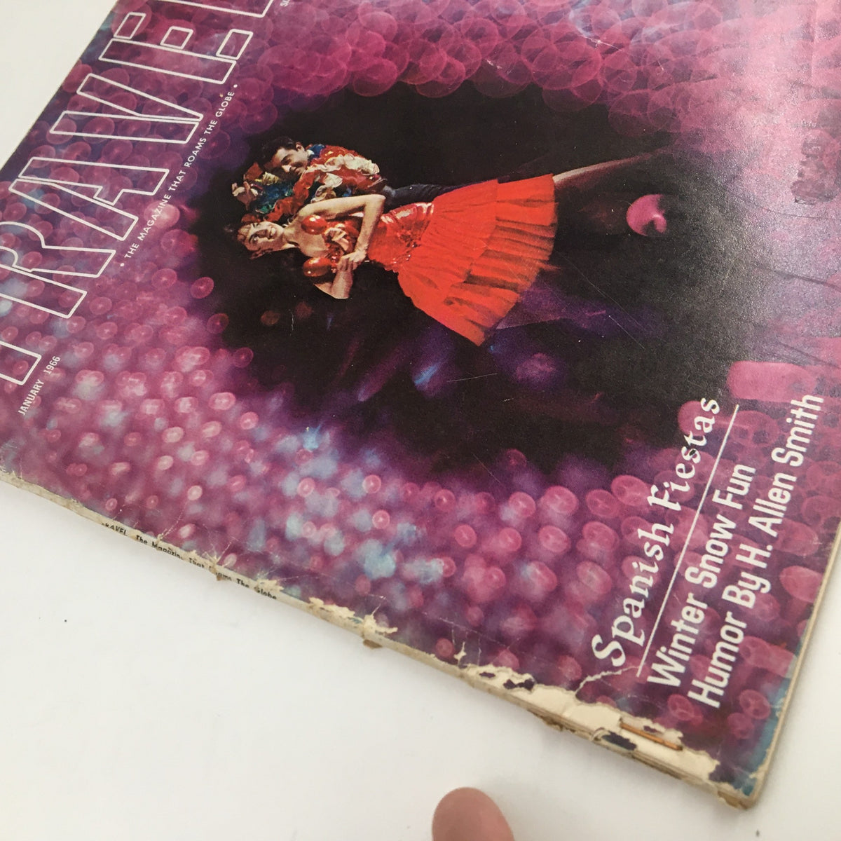 Cover of VTG Travel Magazine January 1966 featuring vibrant colors and models in winter attire, showcasing humor by H. Allen Smith alongside Spanish Fiestas.