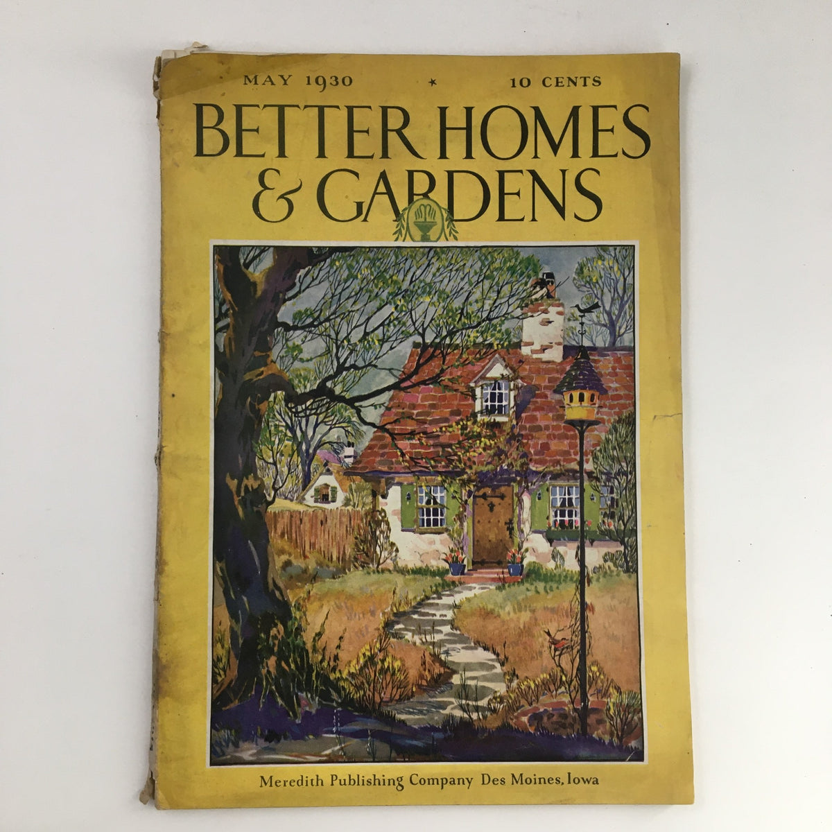 Cover of Better Homes & Gardens May 1930 magazine featuring a picturesque home and garden scene, showcasing the theme 'The Friendly, Useful Lights of the Garden.'